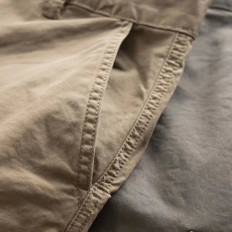 Men's solid colour cotton labour protection trousers in cropped length with multiple pockets, shown in khaki.