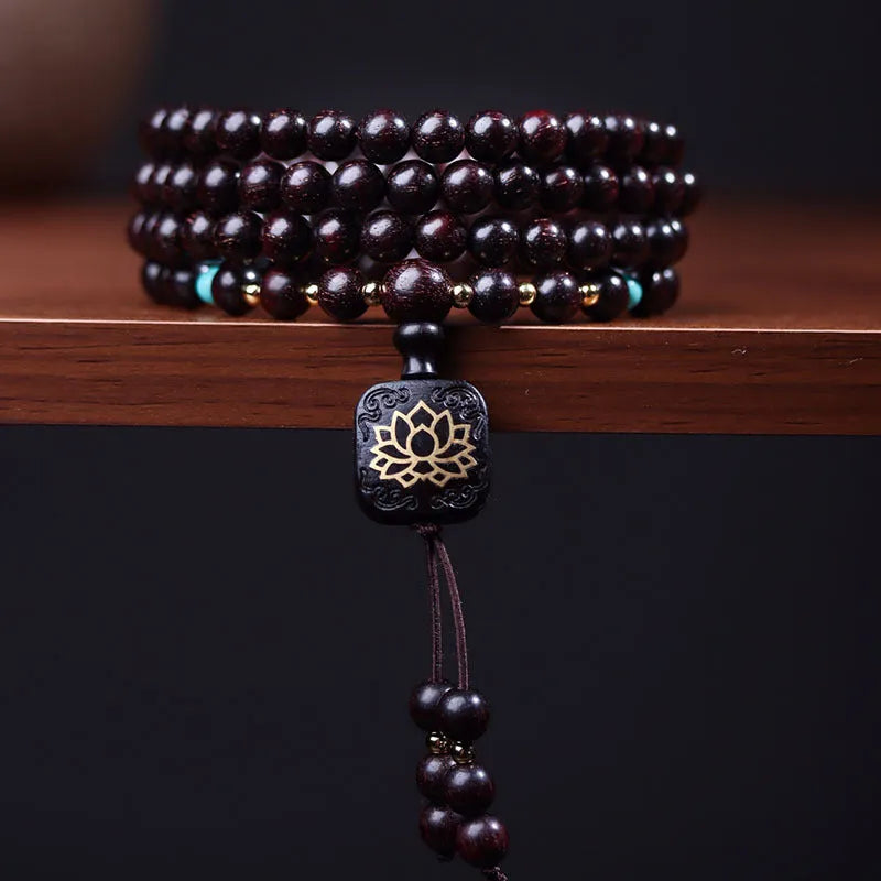 Zambia rosewood Buddha bead bracelet with flat lotus pendant, showing 108 wooden beads.