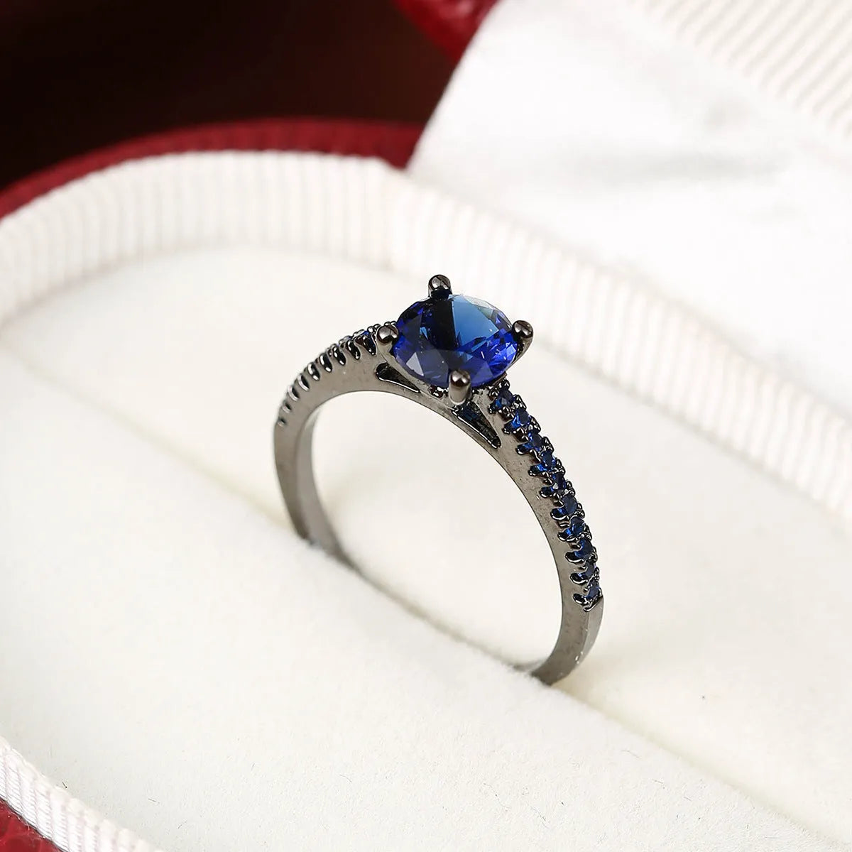 Geometric hexagon zircon fashion ring in electroplated copper on a hand, showing gold and gun black colour options.