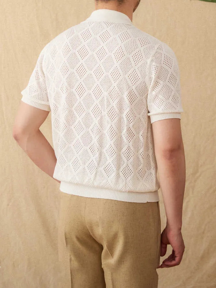 Light brown cotton cardigan top with lapel collar, short sleeves, and a centre front zipper on a hanger.