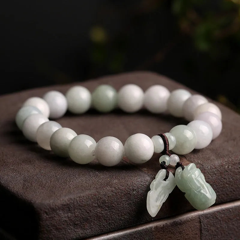 Green jade geometric bracelet with hanging Maitreya Buddha pendant on wrist