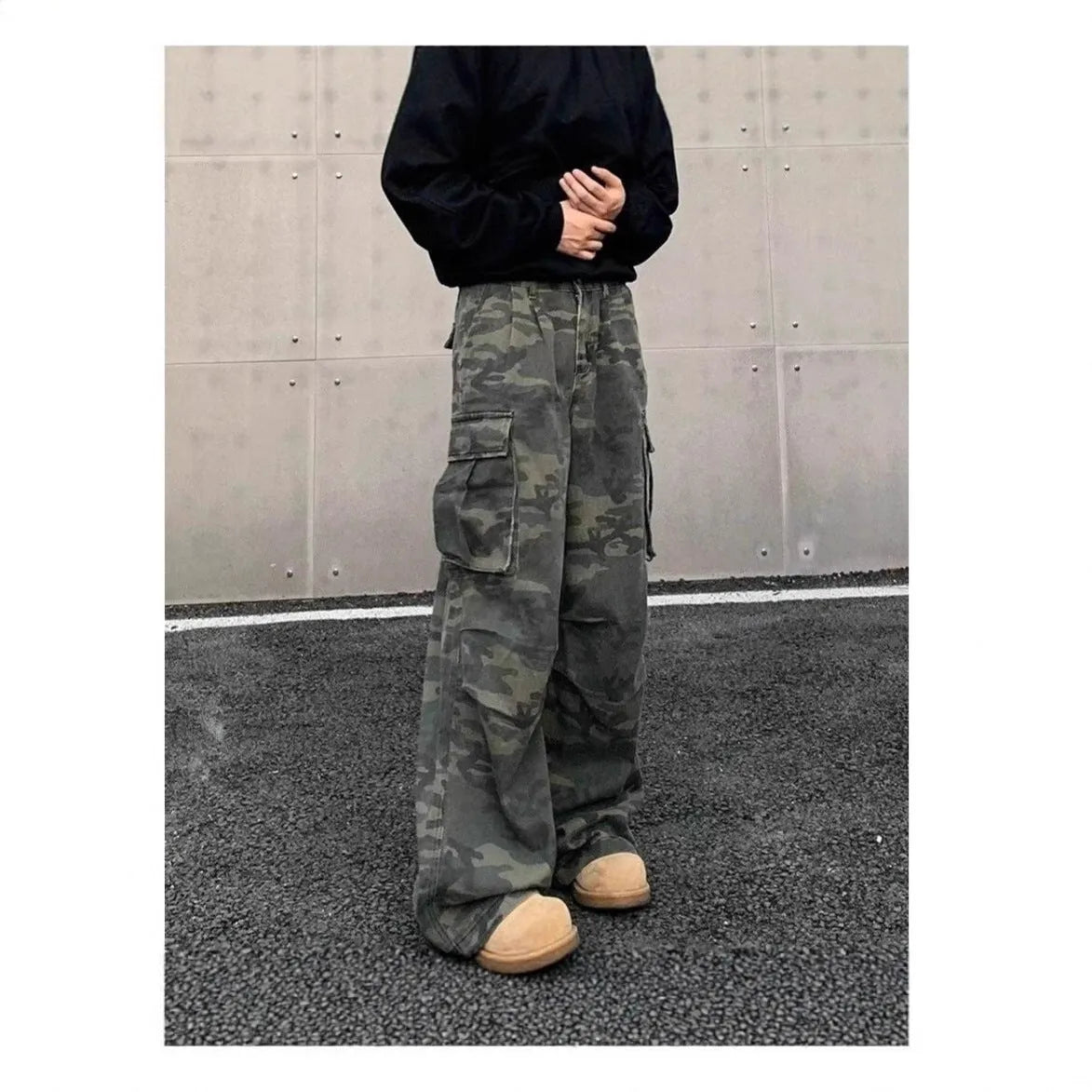 Washed camouflage cargo trousers with multiple pockets on a mid-waist fit.