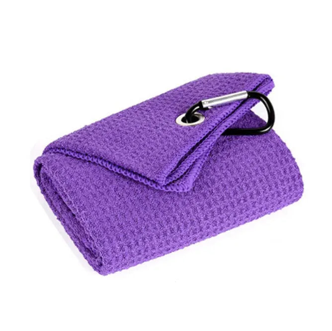 Waffle weave golf ball cleaning cloth in blue, showing textured surface and rectangular shape.