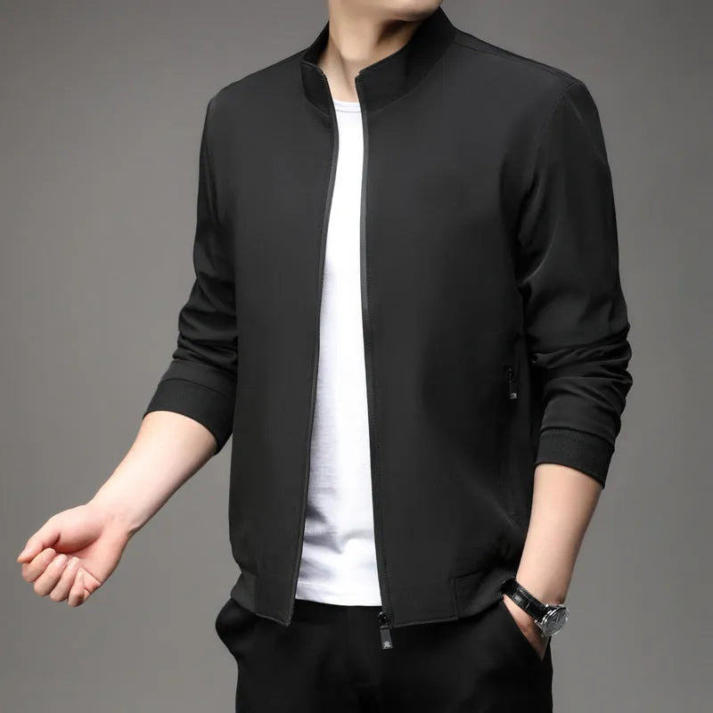Man wearing a black Korean-style loose lapel casual jacket with zipper pockets.