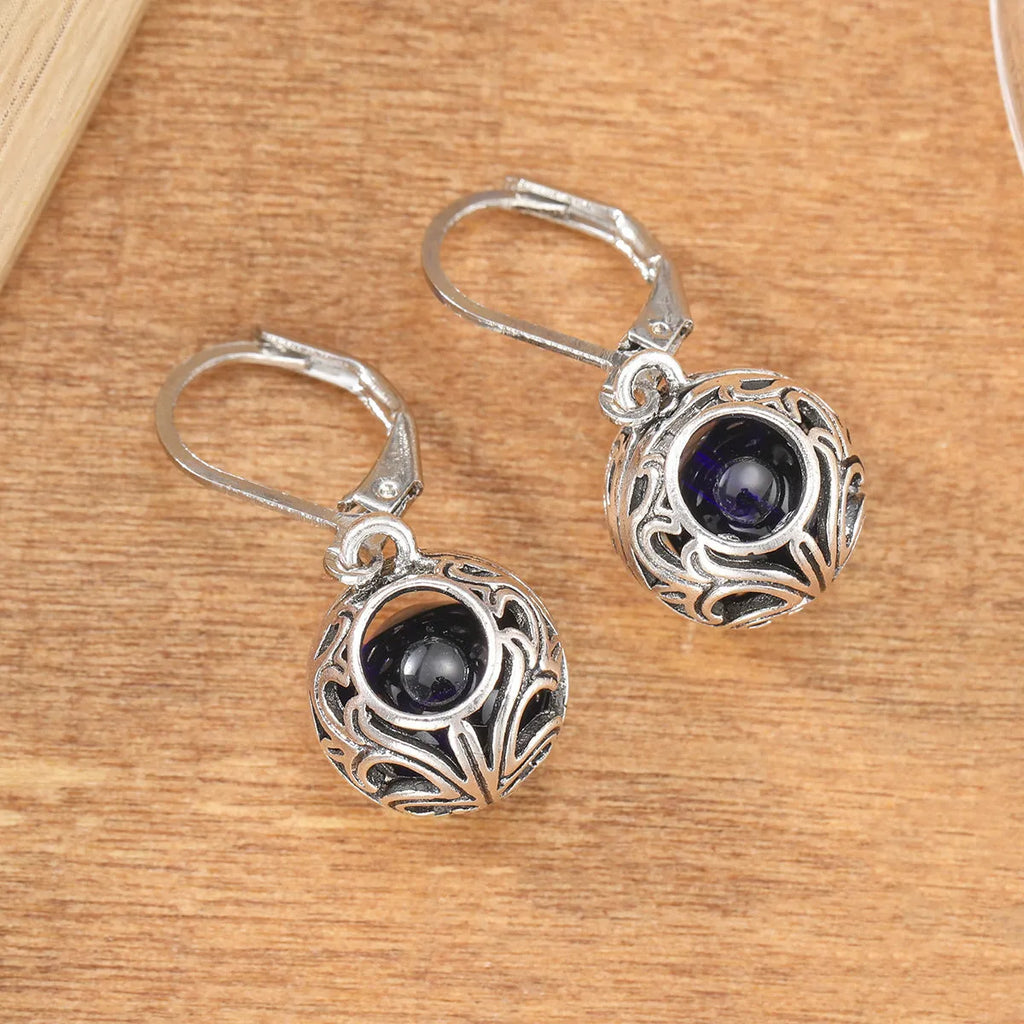 Women's geometric earrings with vintage engraving and hollow blue gemstone pendants in silver colour
