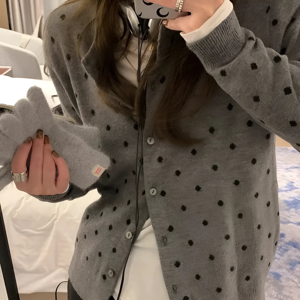 Women's loose-fit gray dot patterned knitted cardigan in black, showcasing crocheted flower detail.