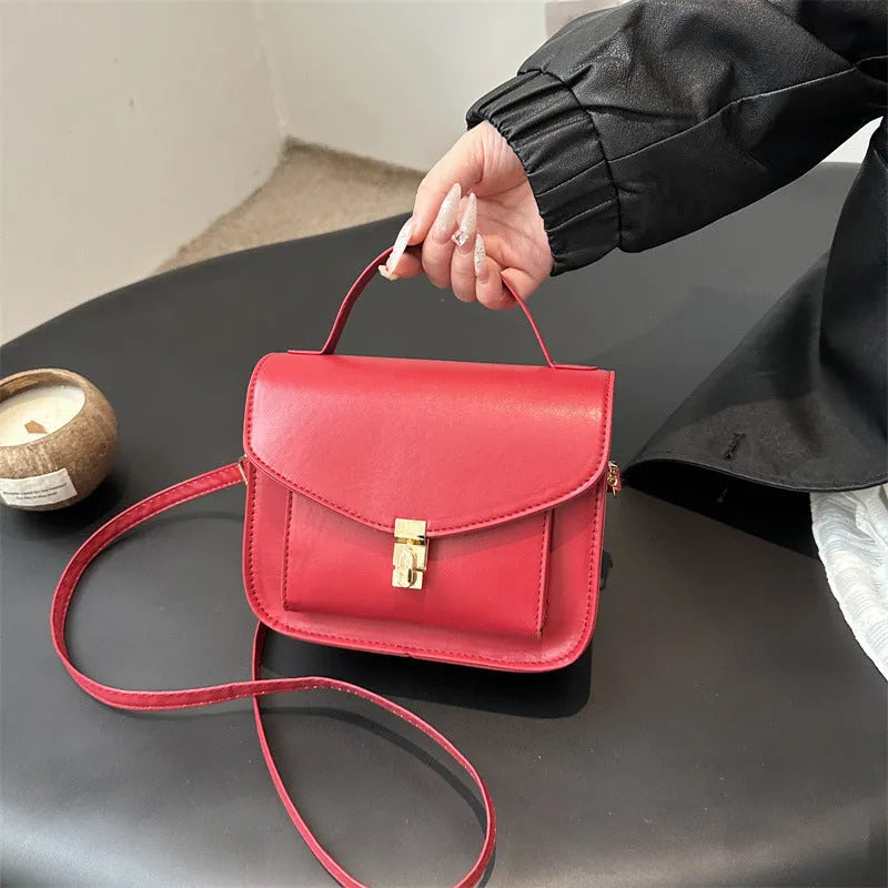 Shoulder messenger bag in horizontal square shape with sewing line detailing and crossbody strap