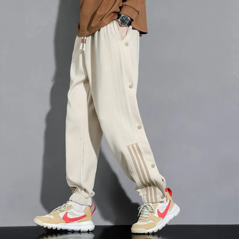Men's loose grey sweatpants with ankle ties and a drawstring waist