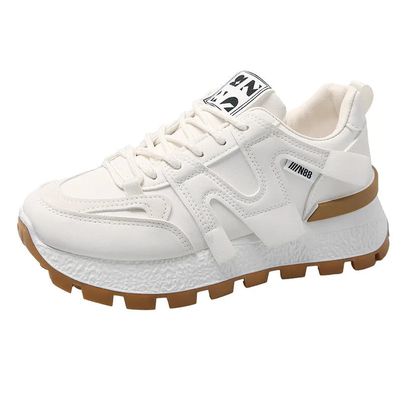 Low top unisex running sneaker in black or white with round toe and flat rubber sole.
