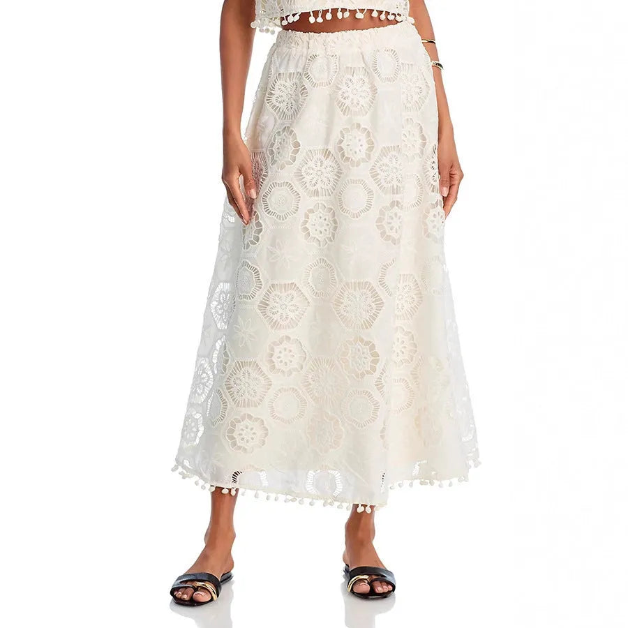 White women's retro style suit set with sleeveless top and embroidered long skirt.