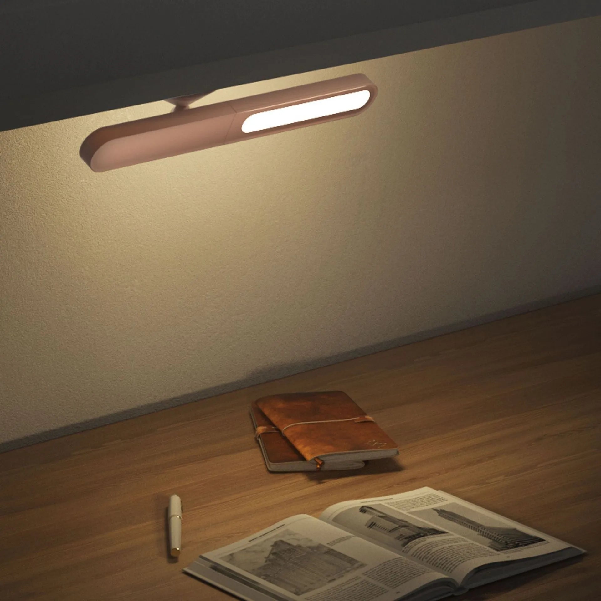Geometric shaped white desk lamp with a magnetic base on a wooden table next to a book.