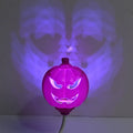 Plastic pumpkin lamp with USB cable showing yellow and purple light options
