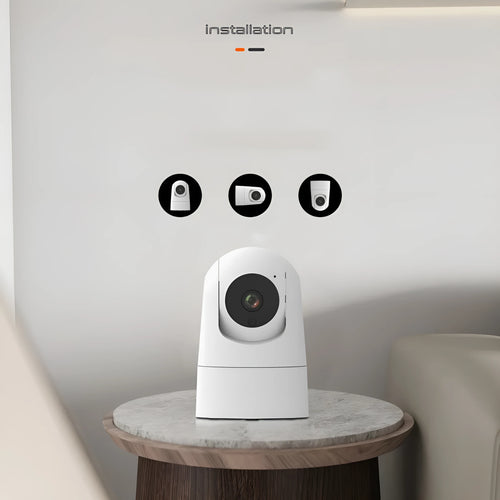 White indoor pan tilt security camera with microphone and speaker for two-way voice on a desk.