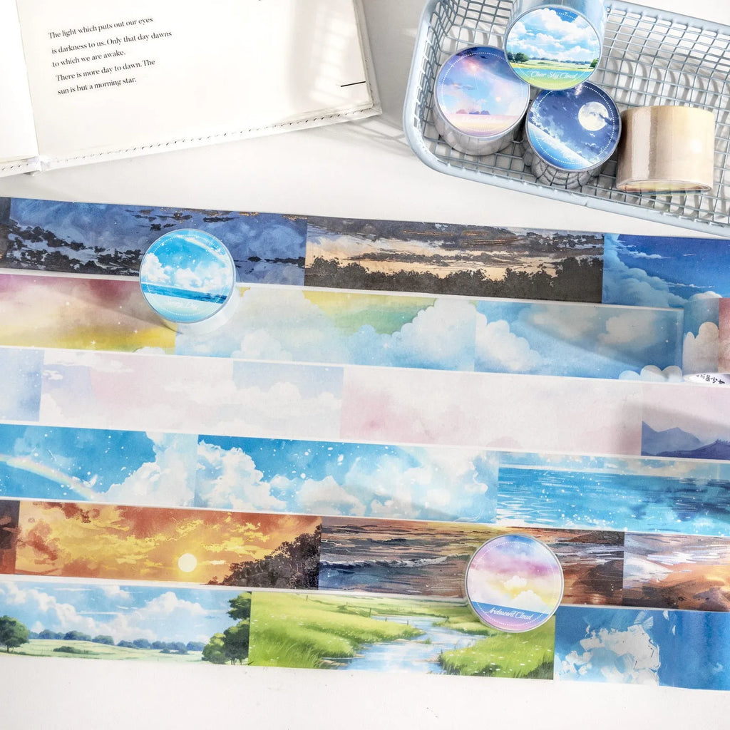 Roll of Japanese washi tape with sky theme designs including clouds, sun, moon, and nebula on a 30mm wide format.