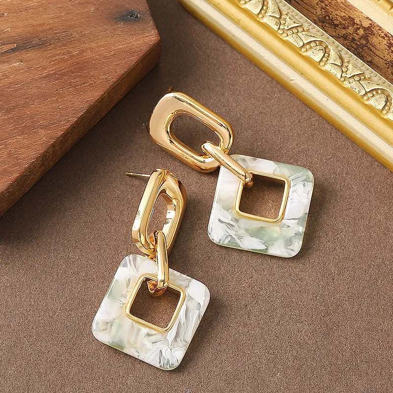 Copper geometric square earrings with hollow design and chamfered corners in metallic finish