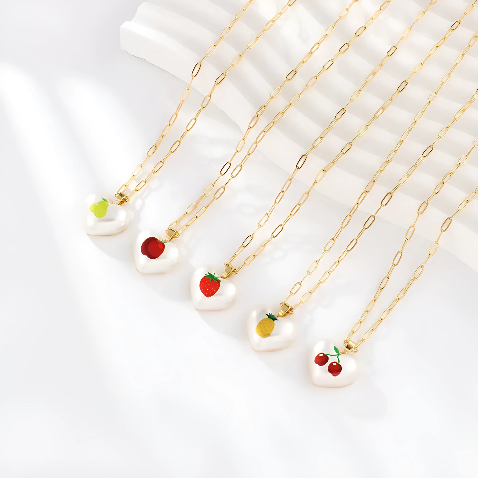 Girl's adjustable necklace with a heart and geometric fruit charms on a chain