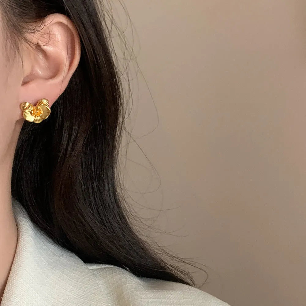 Women's retro floral copper earrings with electroplated gold or silver finish showing petal flower design