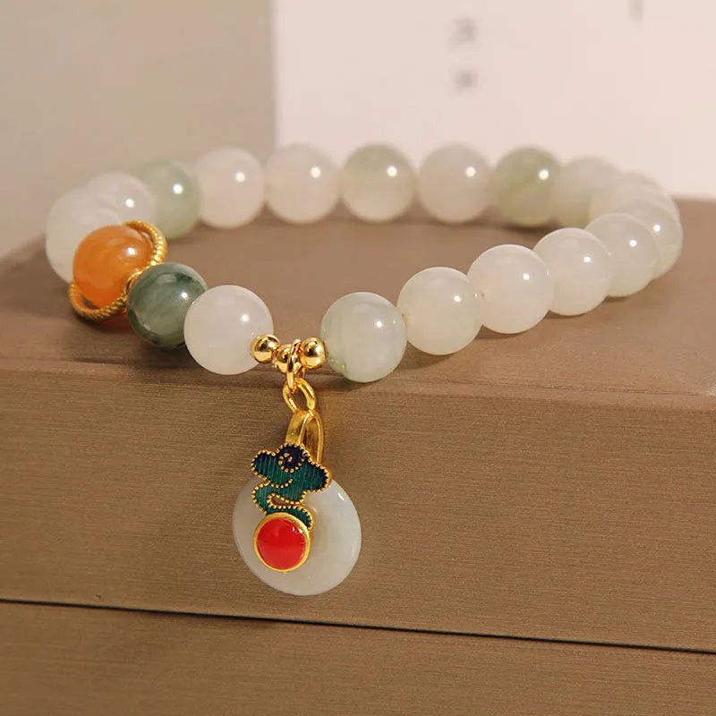 Women's ice jade crystal bracelet with pearl accents and a Xiangyun jade buckle on a white background.