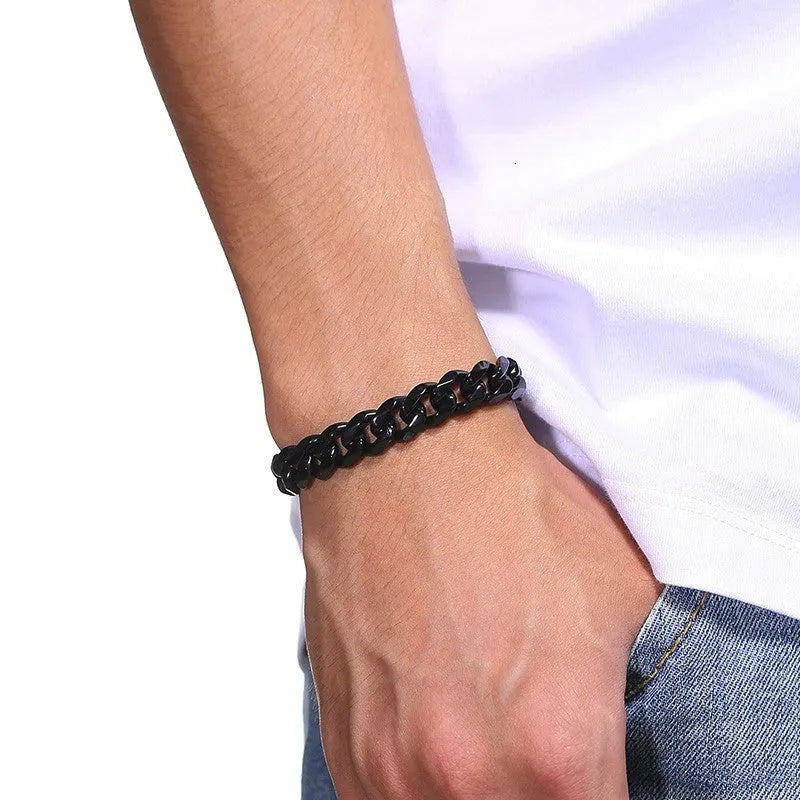 Six-sided Cuban link metal bracelet in gold, black, and steel colour finishes on a wrist.