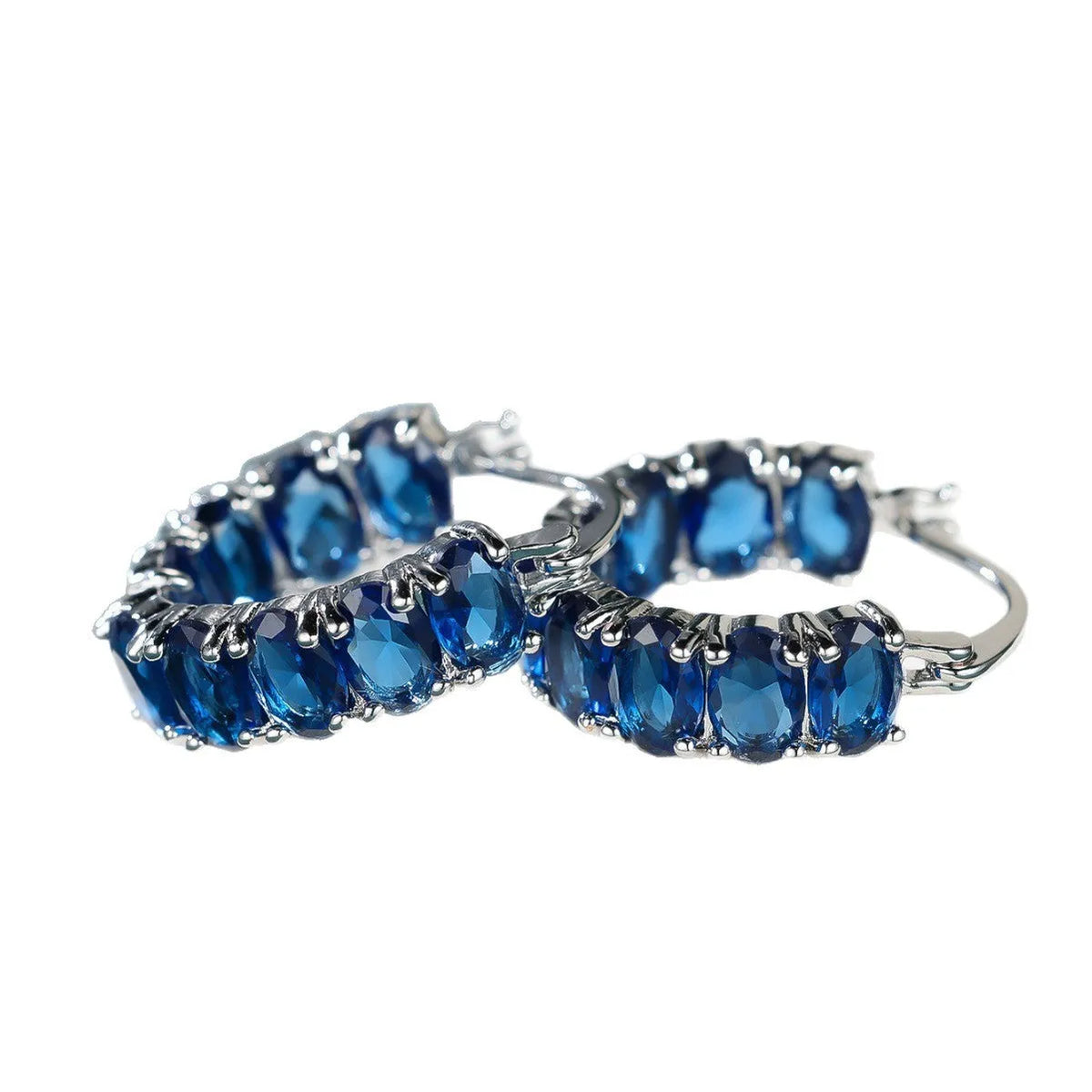 Egg-shaped ear clip earrings for women in electroplated copper, shown in platinum emerald, platinum sapphire blue and gold red