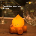 Silicone small fire pile cartoon night lamp with ABS shade on a surface