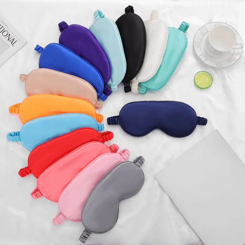 Double-sided silk-like eyeshade mask in rayon elastic satin showing multiple colour options.