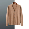 Man wearing a loose beige Andy velvet V-neck cardigan coat with long sleeves