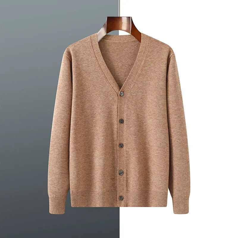Man wearing a loose beige Andy velvet V-neck cardigan coat with long sleeves