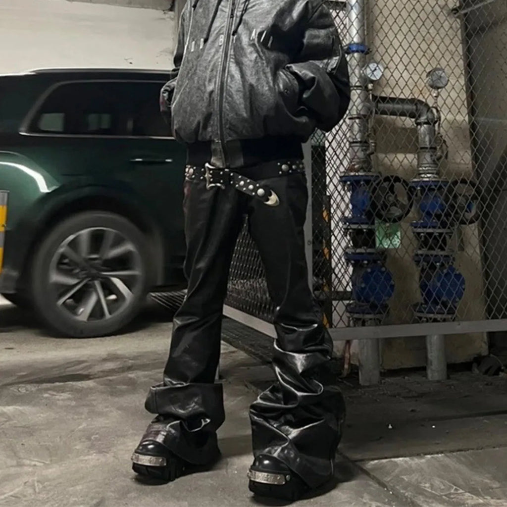 Black coated shiny patent leather straight leg skinny jeans on a hanger.