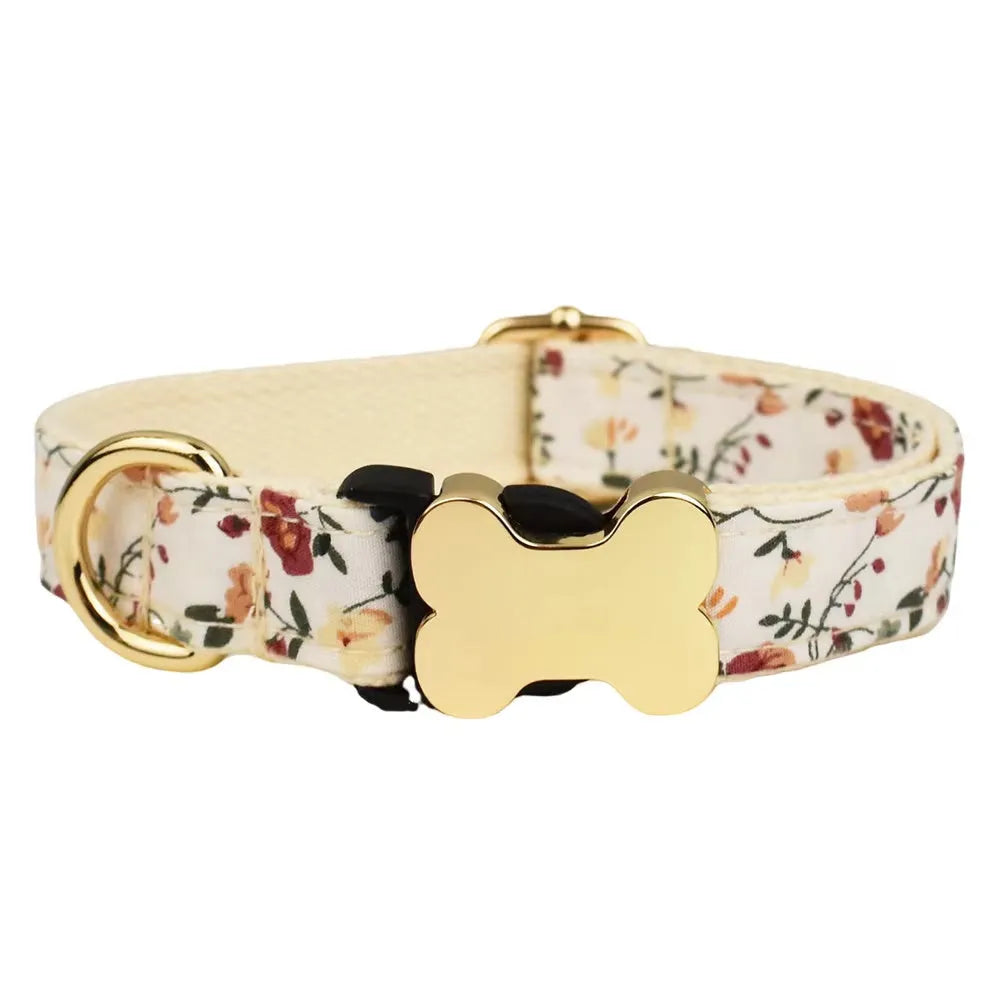Flat nylon dog collar with a grid print and a silver bone-shaped metal buckle on a green background.