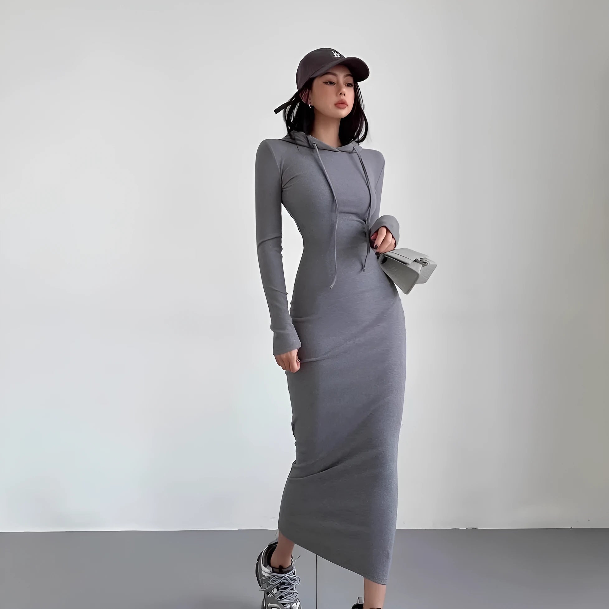 A woman's long sleeve hooded sheath dress in polyester, showing the high waist and over-the-knee length.