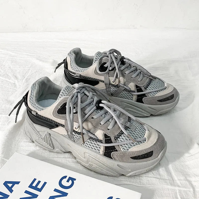 Men's white platform dad shoes with lace-up front on a neutral background.