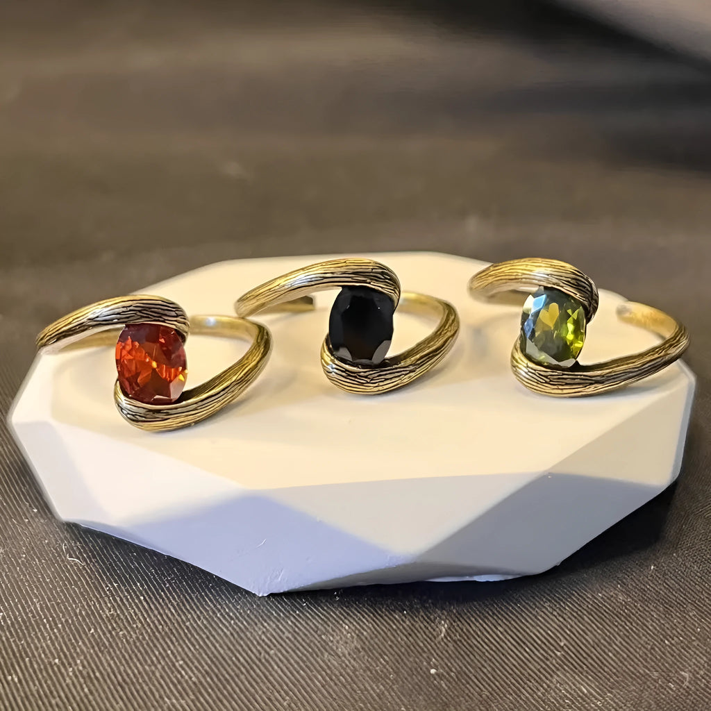 Copper adjustable ring with brushed finish and diamond coloured gem in retro heart shape