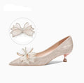 Women's champagne gold sequin pointed-toe stiletto heel pumps on a white background.