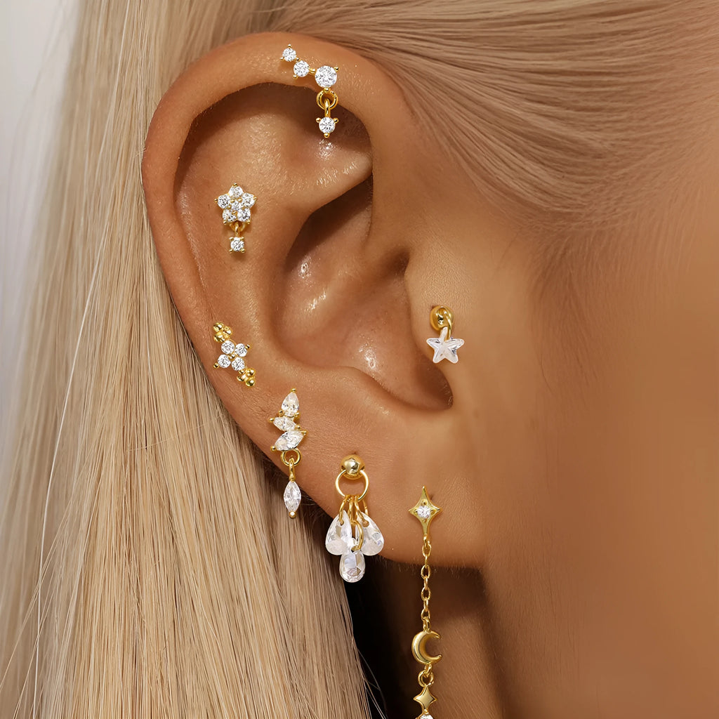 S925 sterling silver geometric moon and star earrings with embedded diamonds on a gold-coloured background.