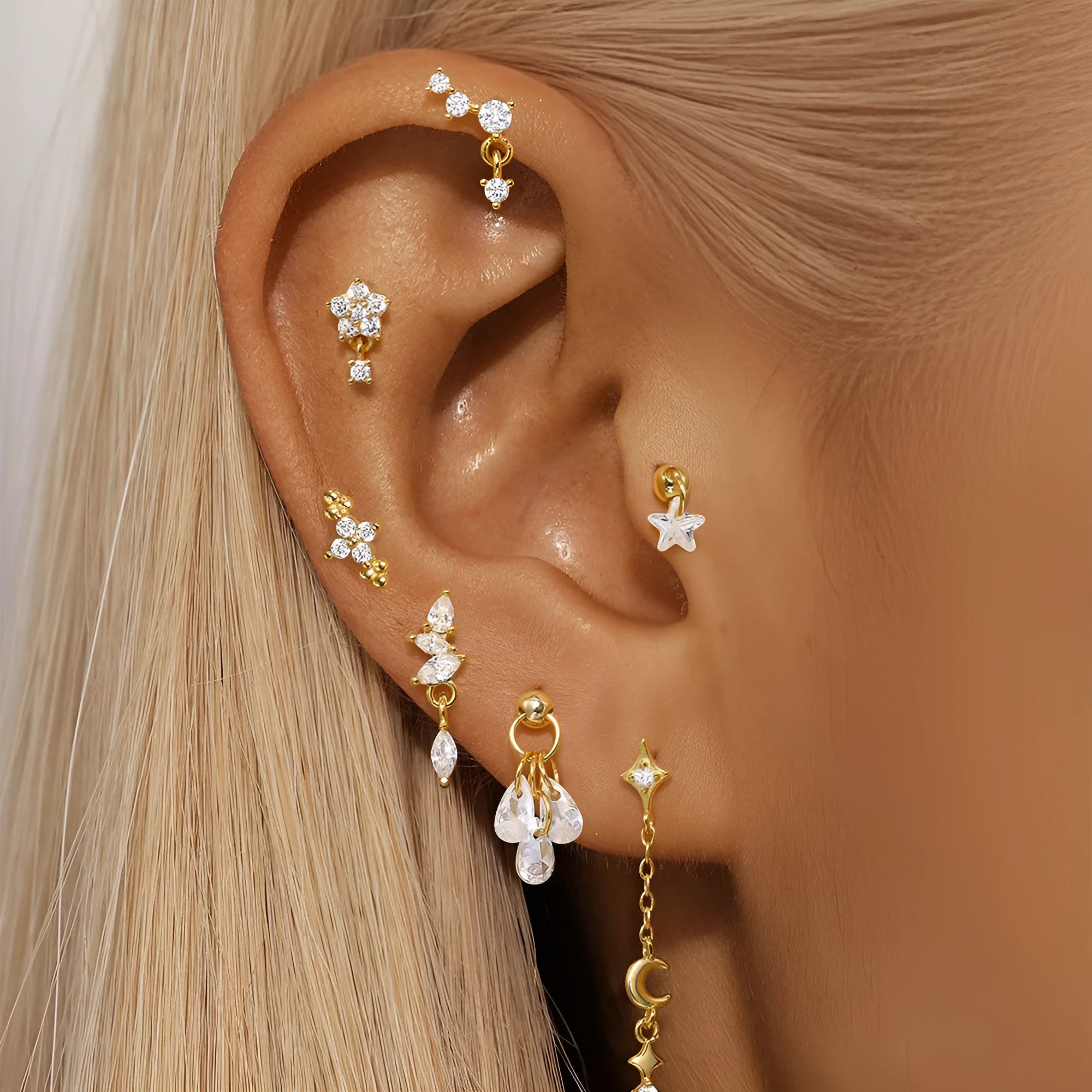 S925 sterling silver geometric moon and star earrings with embedded diamonds on a gold-coloured background.