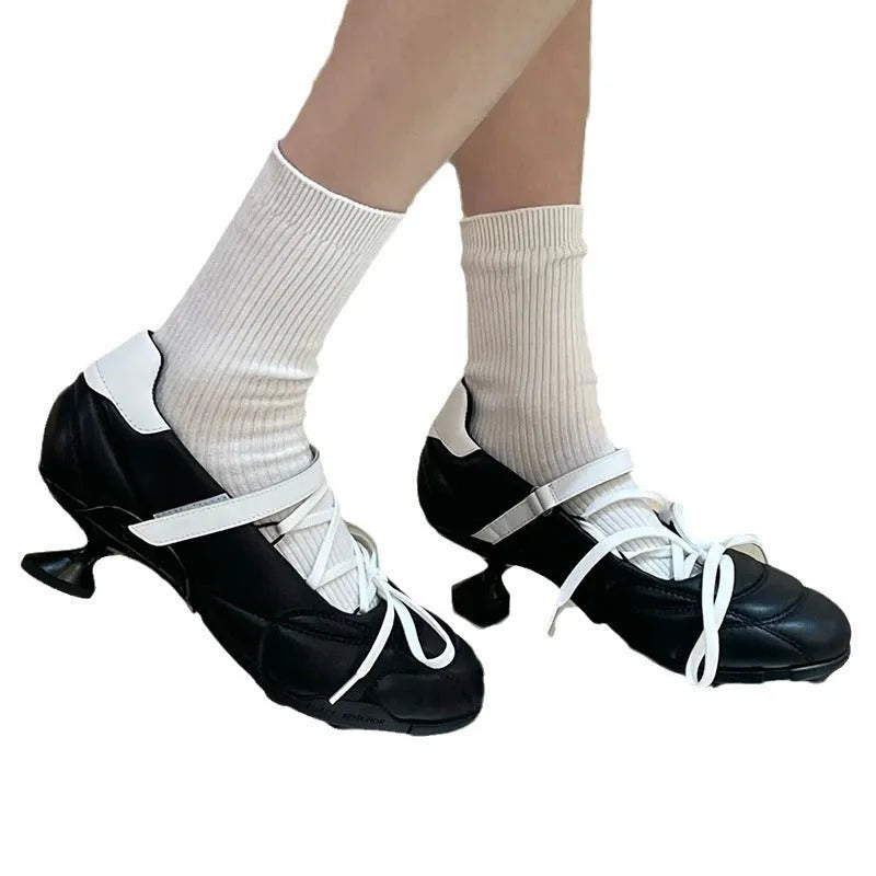 Women's silver lace-up bow sports shoes with a round toe and mid heel on a white background