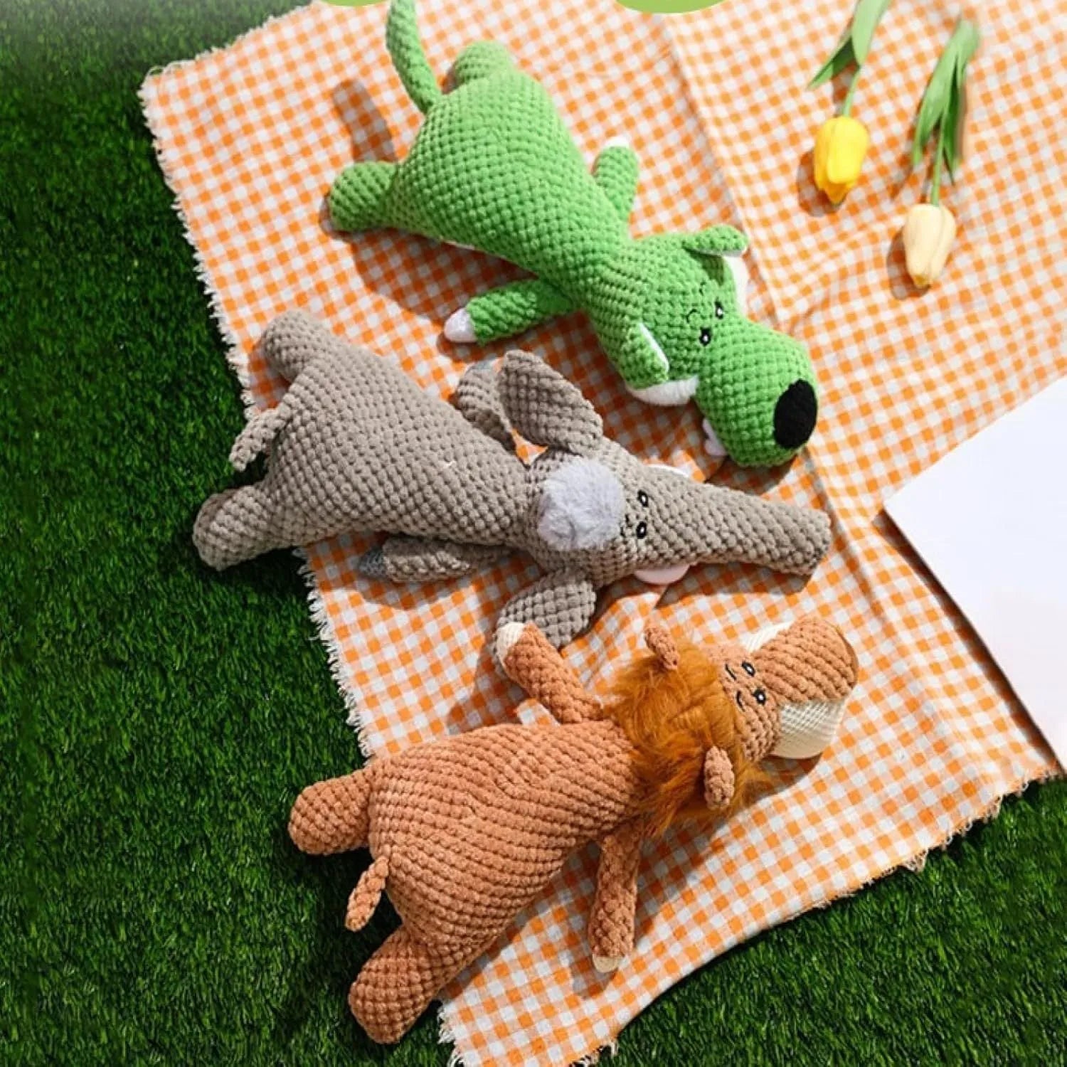 Plush animal-shaped dog toy with a bumpy corn kernel texture, shown in grey, green, and yellow colours.