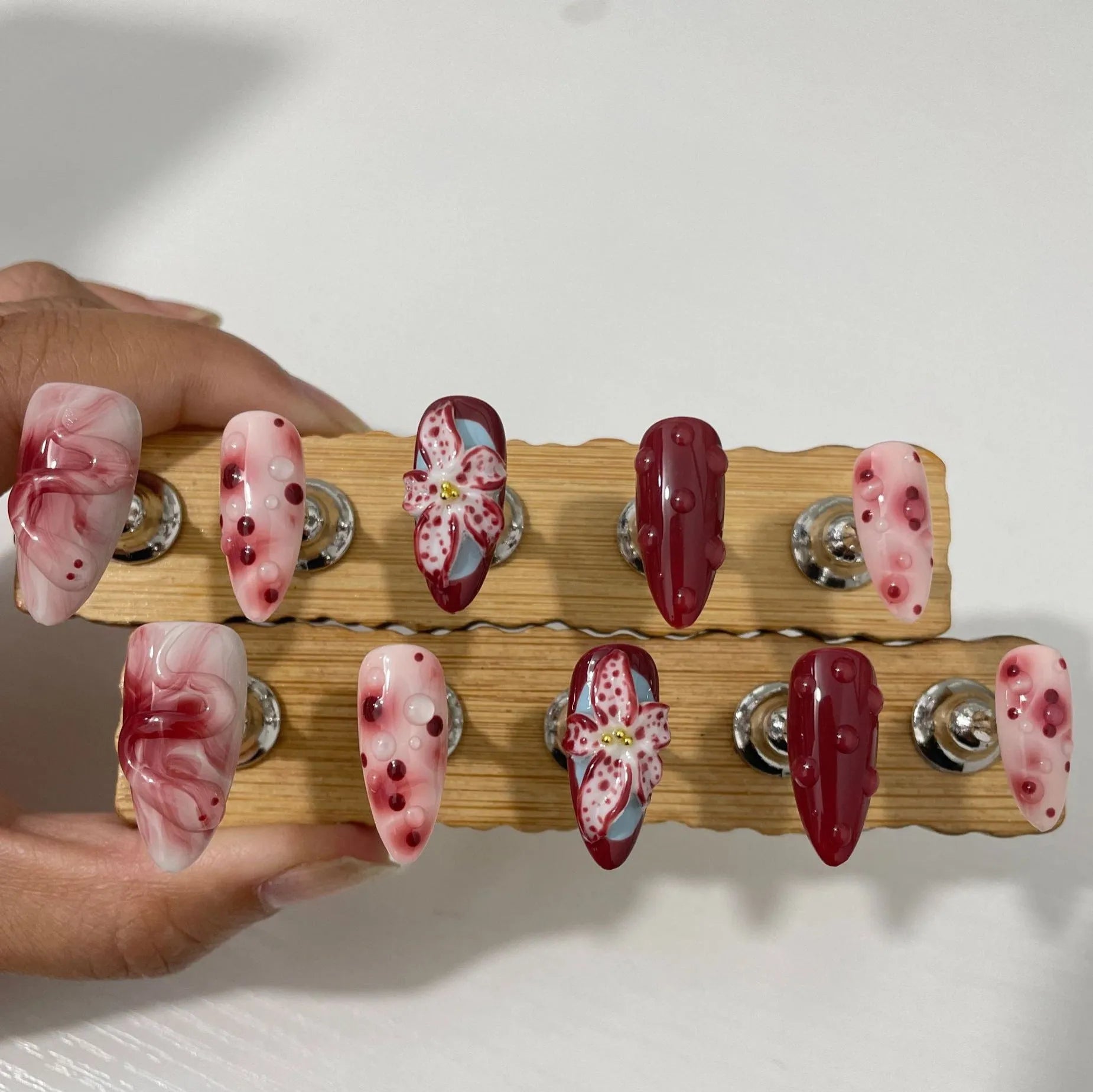 Medium length hand-painted manicure nails with blooming flower 3D carving design in almond colour