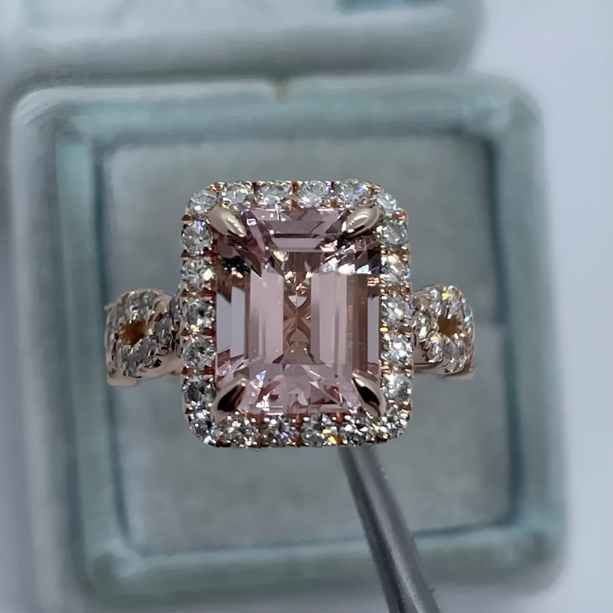 Geometric rose gold alloy ring on a plain background showing its shape and electroplated finish.