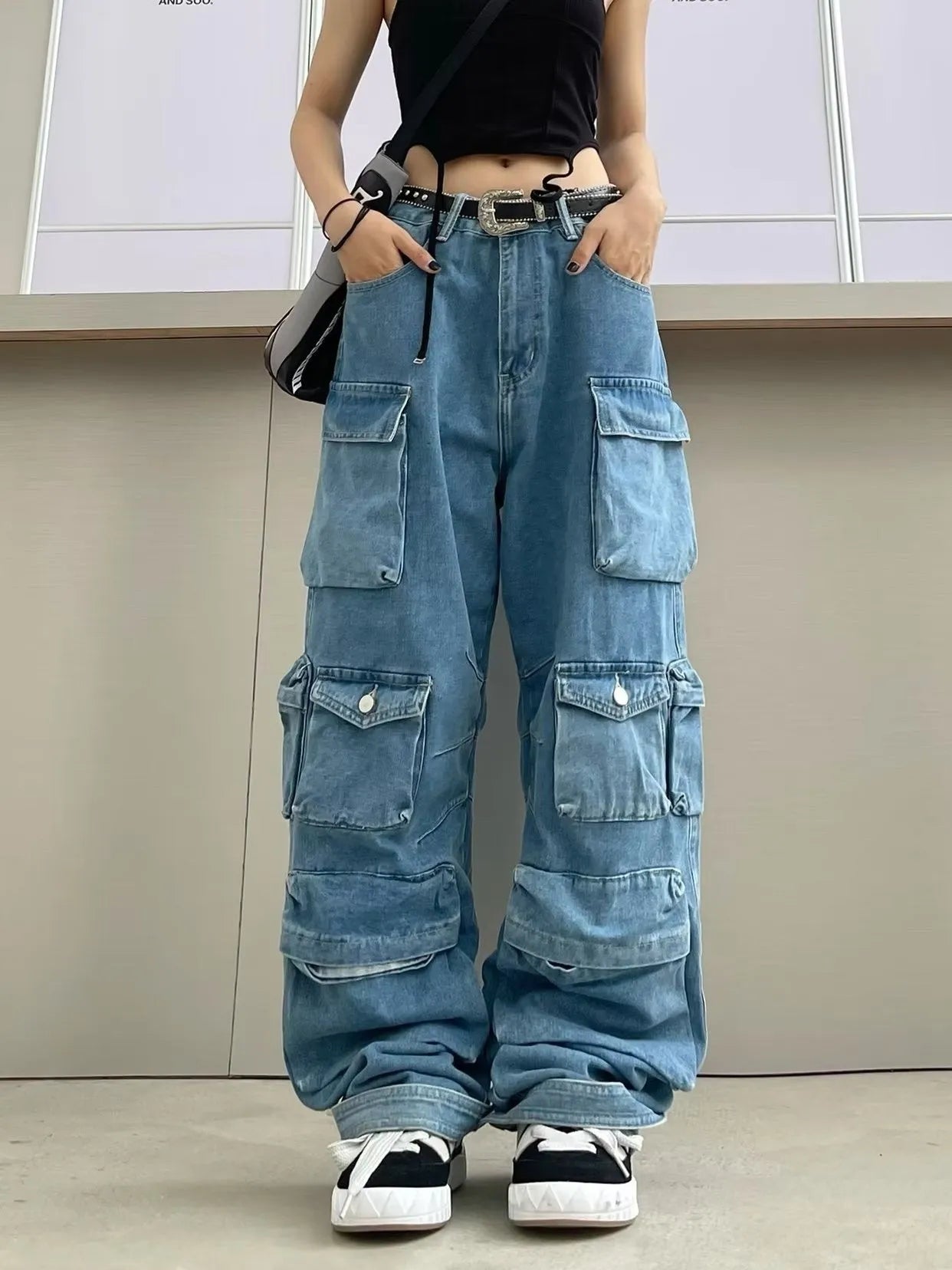 Women's blue tie-dyed wide-leg high-waist jeans with multiple pockets on a mannequin.