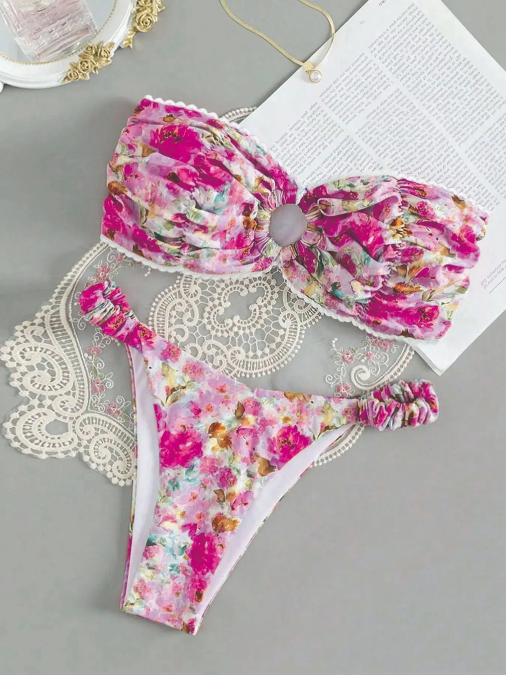 Floral print blue bikini tube top with lace trim and backless design for swimming.