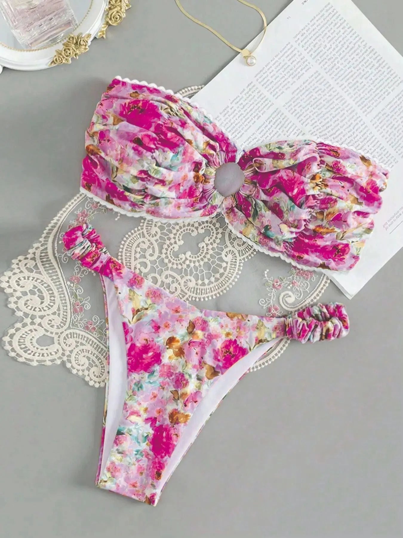 Floral print blue bikini tube top with lace trim and backless design for swimming.