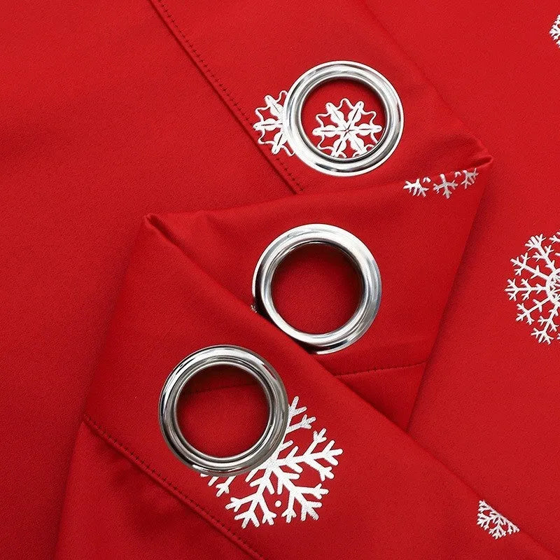 Red snowflake pattern shade cloth curtain with lace loops hanging against window
