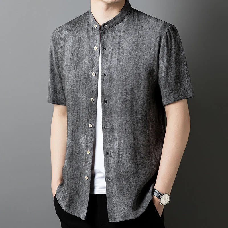 Man wearing a loose-fit black grey linen blend cardigan shirt with a stand collar.