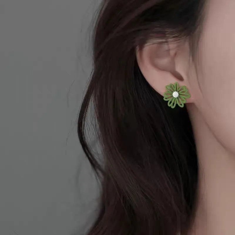 Flower-shaped alloy stud earrings in three colour combinations: blue-orange, white-green, and yellow-white