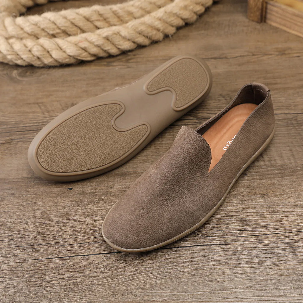 Handmade grey low top men's shoes with a wedge heel and rubber sole.