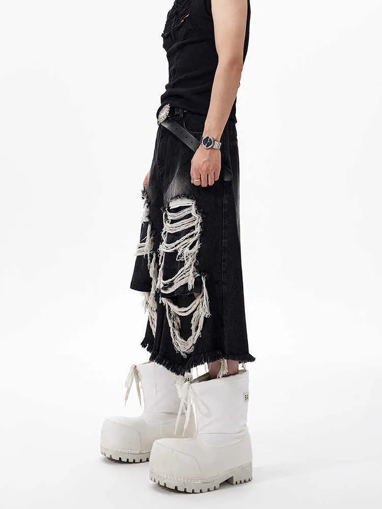 Women's black cropped wide-leg jeans with distressed patch details and mid-high waist