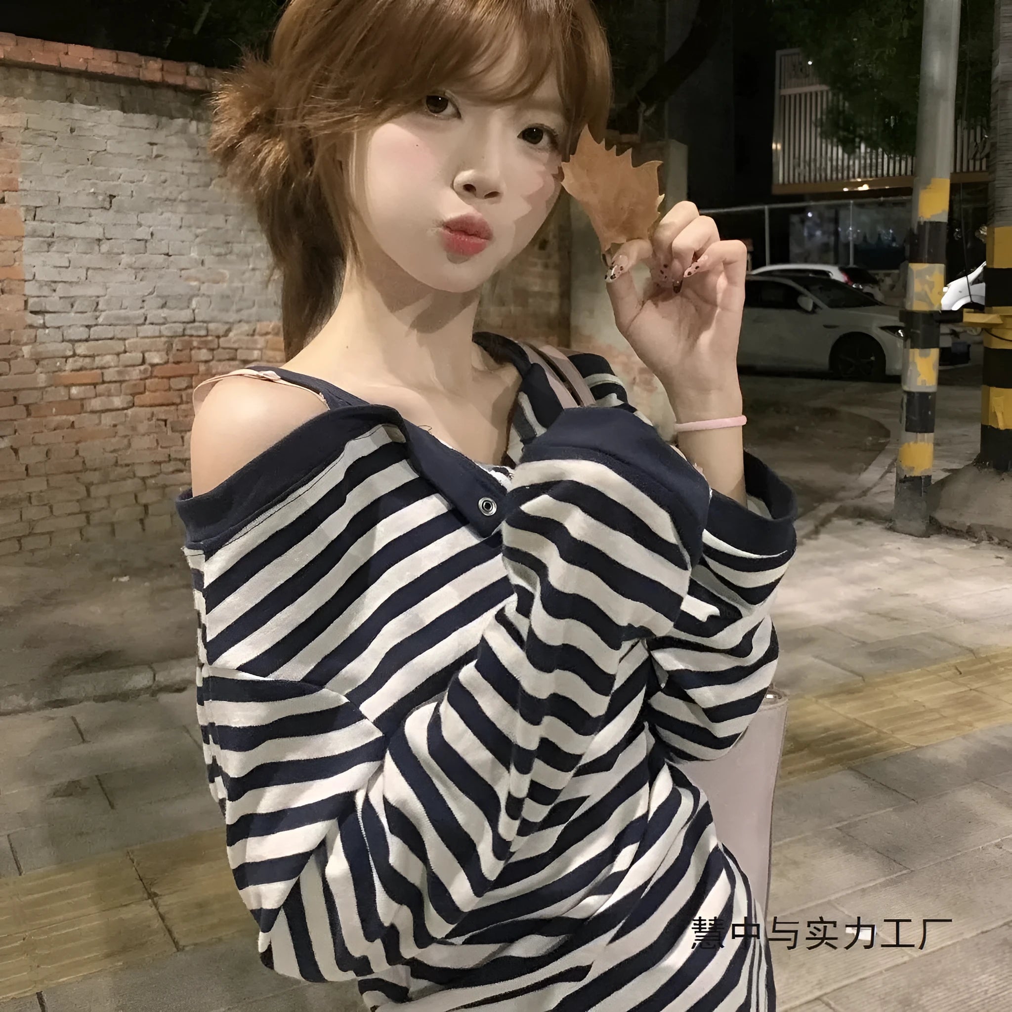 Dark blue Korean-style oversized women's long-sleeved t-shirt with stripes and embroidery detail.