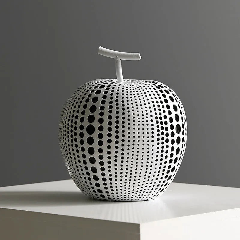 Resin craft decorative apple sculpture in black tall model with smooth finish on a white table